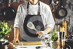 Cooking, profession and people concept - male chef cook making food at restaurant kitchen photo