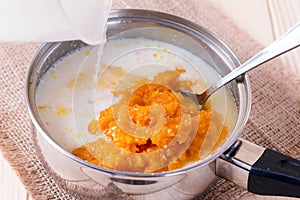 Cooking pumpkin porridge with milk in a saucepan