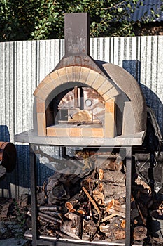 Cooking real pizza in a brick oven. Wood and fire are burning