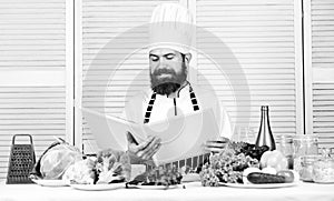 Cooking by recipe. Happy bearded man. chef recipe. Dieting organic food. Healthy food cooking. Mature hipster with beard