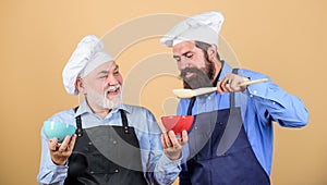 Cooking by recipe. professional restaurant cook. new recipe. Perfect taste. mature senior bearded men in kitchen. taste