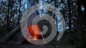 Cooking roasted meat in a Cozy tipi in the dark scandinavian forest