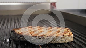 Cooking salmon on an electric grill in a restaurant.