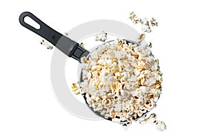 Cooking salted popcorn in a skillet. Isolated, white background.