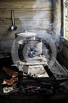 Cooking in saucepans on an improvised stove over a fire