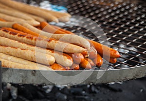 Cooking sausages on the grill