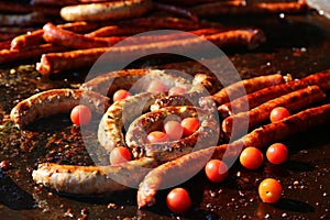 Cooking sausages and tomatoes