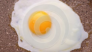 Cooking scrambled eggs in frying pan. Top view, selective focus. Timelapse.