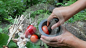 Cooking seafood kebab over a campfire in the forest