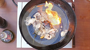 Cooking seafood in pan with flame