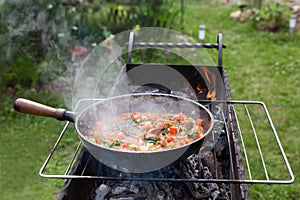Cooking shakshuka in the pan on the grill