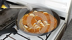 Cooking Shell in Pomodoro sauce. The Traditional italian food name Clams in Pomodoro Sauce