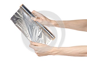 Cooking and shisha topic: human hand holding a foil isolated on