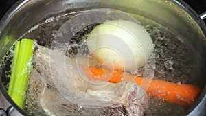 Boiling beef stock in stew pan close up close up