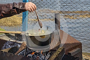 Cooking soup on the nature in a cauldron