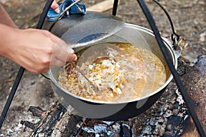Cooking soup over campfire in hike