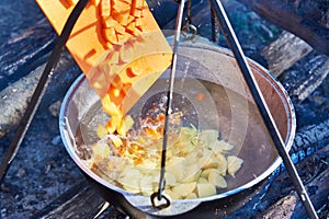 Cooking soup in the stowed bowler over campfire