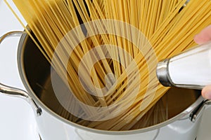 Cooking spaghetti noodles pasta meal: salting water in pot photo