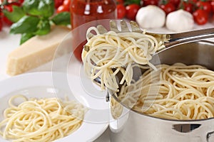 Cooking spaghetti pasta: serving noodles on plate