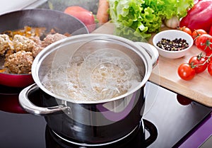 Cooking spaghetti in a pot with boiling water