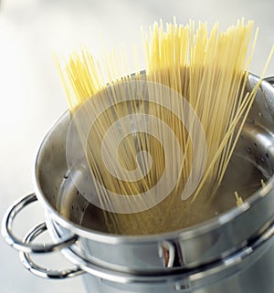 Cooking spaghettis in a stewpot photo