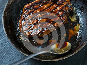 Cooking steak with butter basting motion blur