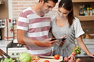 Cooking, tablet and couple learning in kitchen for healthy food or vegetables for lunch or dinner. Online, tutorial or