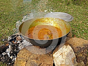 Cooking tasty delicious indian food item during a picnic or outdoor camp