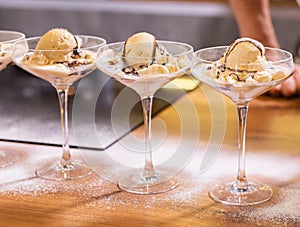 Cooking tasty ice cream dessert made from chocolate and vanilla in glass bowl