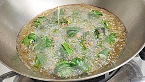Cooking to frying the chicken wrapped in pandan with oil in hot