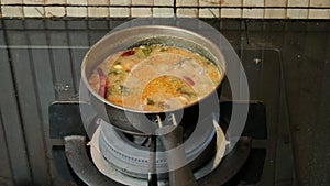 Cooking Tom Yum Soup in a small pot. using a gas stove Set aside for eating in the family.