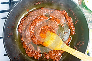 Cooking tomato sauce in a frying pan