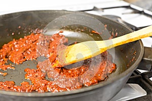 Cooking tomato sauce in a frying pan