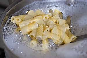 Cooking tortiglioni pasta, boiling water at the pan...