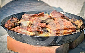 Cooking of traditional balkan turkish bosnian dalmatian meal Peka in metal pots called sac sach or sache. Traditional roast of po