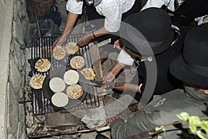 Cooking traditional corn bread in a party. Ecuador photo