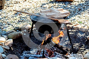 cooking traditional goulash in a 12 liter cauldron