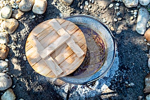 cooking traditional goulash in a 12 liter cauldron