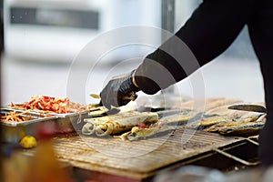Cooking traditional street food balik in lavash in Istanbul, Turkey. It is grilled mackerel fish in lavash with vegetables and
