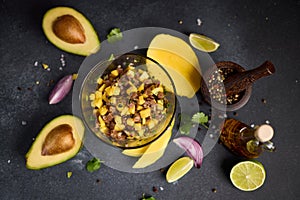 Cooking traditional tuna and mango tartare - chopped and mixed tuna, mango, cilantro and onion in a glass bowl