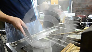 Cooking Udon noodles at Osaka, Japan