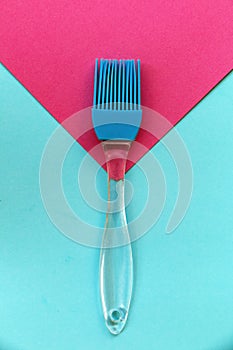 Silicone brush on blue and pink geometric background photo