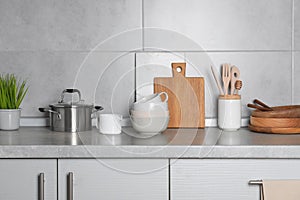 Cooking utensils and other kitchenware on grey countertop