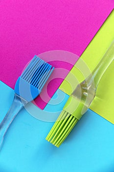 Silicone brushes on bright colored geometric background photo