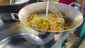 Cooking of vegetable omelette, Tanin market stall, Chiang Mai, Thailand
