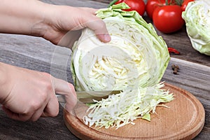 Cooking vegetable salad hands with a knife