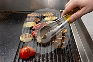 Cooking vegetables grill on the frying surface in black
