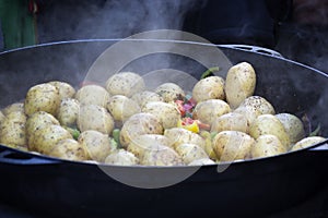 Cooking vegetables in large cast iron cauldron