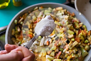 Cooking vegetarian meal. Putting too much salt in vegetables