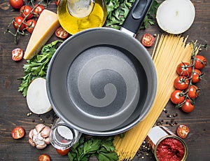 Cooking vegetarian pasta with cherry tomatoes, parsley, onion and garlic, butter, tomato paste and cheese, the ingredients are lai